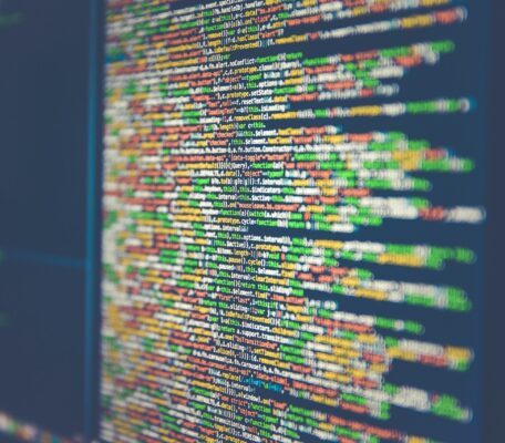 a monitor with colorful data in a dark setting
